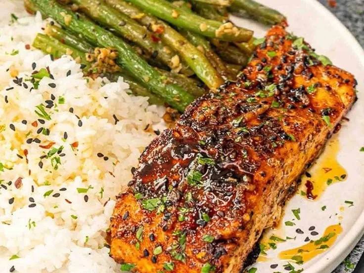 Delicious Cajun Honey Butter Salmon topped with sweet and spicy glaze.