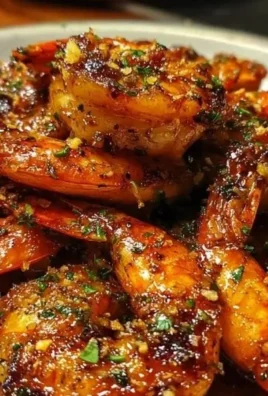 Plate of Cajun Hot Honey Shrimp garnished with herbs and spices