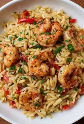 Cajun Shrimp Orzo with roasted peppers and Parmesan in a bowl