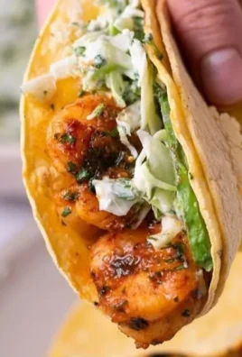 Cilantro lime shrimp tacos served with creamy slaw on a platter.