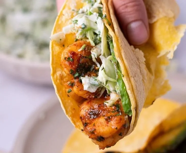 Cilantro lime shrimp tacos served with creamy slaw on a platter.
