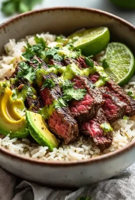 Cilantro lime steak and rice bowls with colorful veggies and fresh lime.