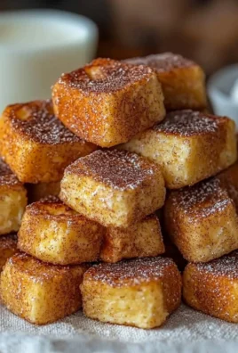 Cinnamon French Toast Bites served on a plate with a dusting of powdered sugar