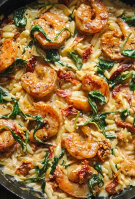 Creamy Tuscan shrimp orzo dish with shrimp, orzo pasta, and rich sauces