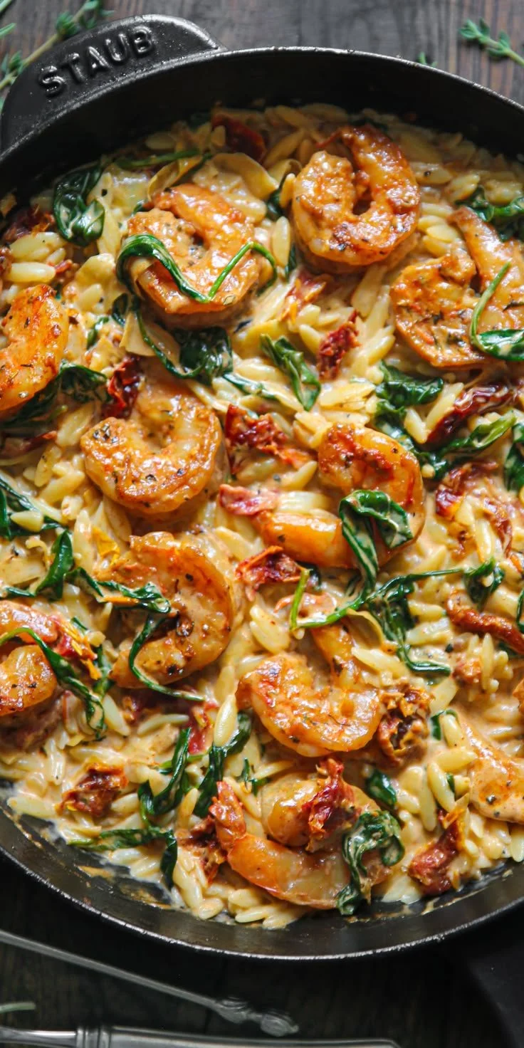 Creamy Tuscan shrimp orzo dish with shrimp, orzo pasta, and rich sauces