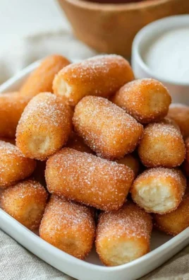Fluffy air fryer churro bites dusted with cinnamon sugar and served warm.