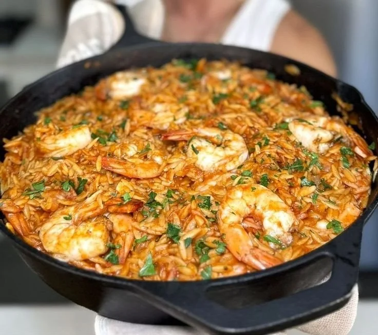 Greek Shrimp with Orzo Youvetsi dish garnished with herbs and spices