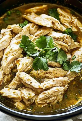 Delicious Green Sauce Crockpot Chicken served in a bowl with fresh herbs