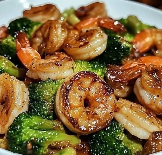 High-protein honey garlic shrimp served with vegetables on a plate.