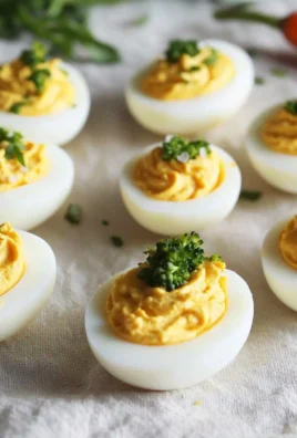 Keto Deviled Eggs topped with seasoning on a plate