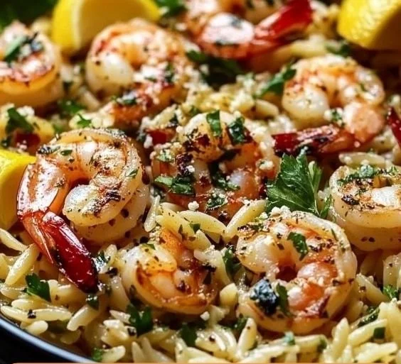 A vibrant dish of Lemon Feta Orzo Shrimp with herbs and lemon zest.