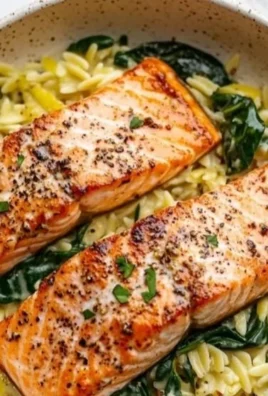 Plate of Mediterranean Salmon served with lemon orzo and fresh herbs