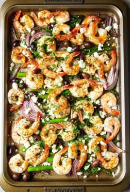 Plate of Mediterranean shrimp garnished with herbs and served with vegetables.