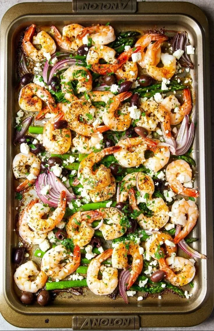 Plate of Mediterranean shrimp garnished with herbs and served with vegetables.