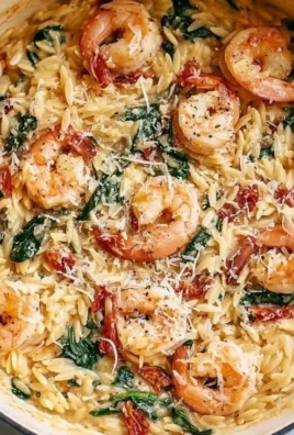 Plate of shrimp orzo with fresh herbs and lemon