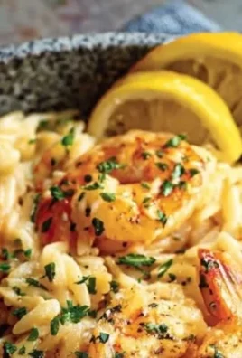 Delicious shrimp orzo cooked in lemon garlic sauce served on a plate