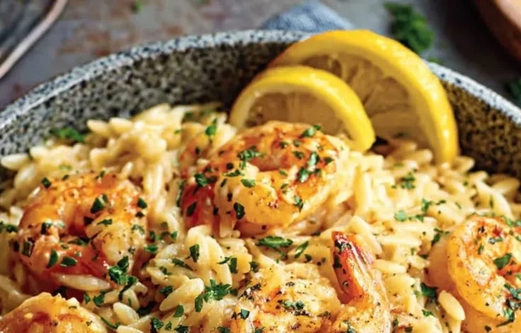 Delicious shrimp orzo cooked in lemon garlic sauce served on a plate