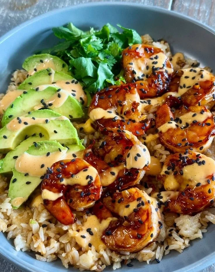 Delicious teriyaki shrimp served in a rice bowl with fresh vegetables.