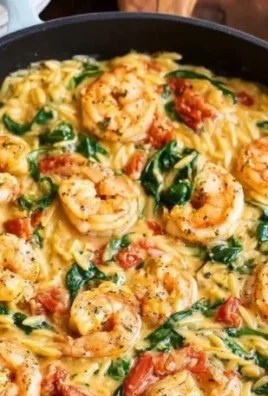 Tuscan shrimp orzo skillet dish with fresh ingredients and vibrant colors