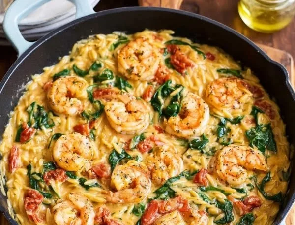 Tuscan shrimp orzo skillet dish with fresh ingredients and vibrant colors