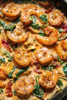 Delicious Tuscan Shrimp with Spinach, Artichokes, and Sun-Dried Tomatoes on a plate