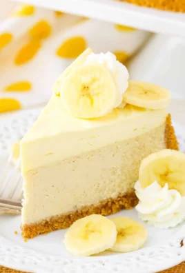 Slice of Banana Cream Cheesecake topped with banana slices and whipped cream