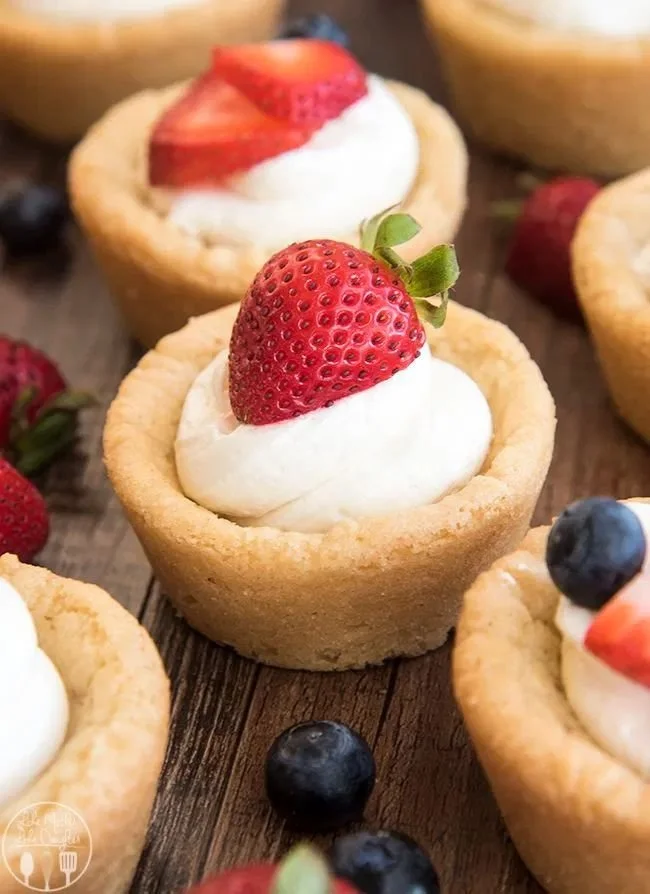 Delicious cheesecake sugar cookie cups displayed on a serving plate.