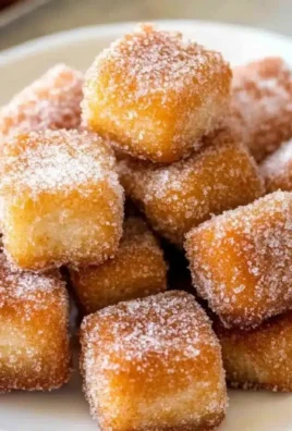Delicious churro bites dusted with cinnamon sugar on a plate