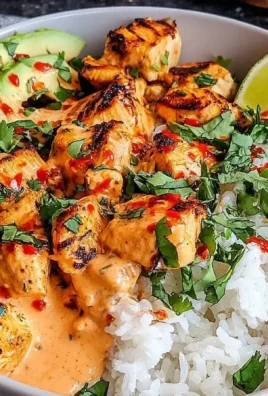 Coconut Chicken Rice Bowl garnished with herbs and served in a vibrant dish