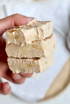 Creamy peanut butter banana frozen yogurt bars topped with sliced bananas