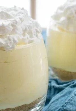 A delicious serving of easy creamy lemon mousse topped with a slice of lemon.