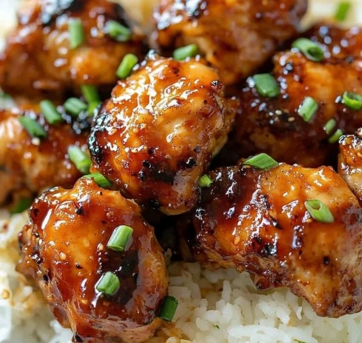 Delicious Firecracker Chicken garnished with green onions and sesame seeds