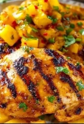 Juicy grilled mango pineapple chicken served on a plate with fresh herbs