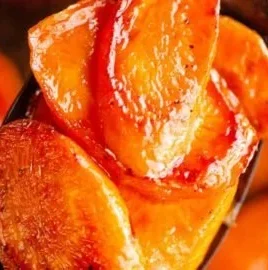 Plate of roasted hot honey carrots garnished with herbs