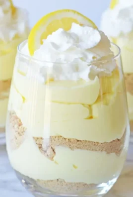 Delicious lemon cheesecake parfaits garnished with lemon zest and berries