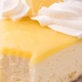 Delicious lemon curd cheesecake topped with fresh citrus zest and a buttery crust