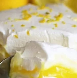 Delicious lemon lush dessert with whipped cream and lemon zest.