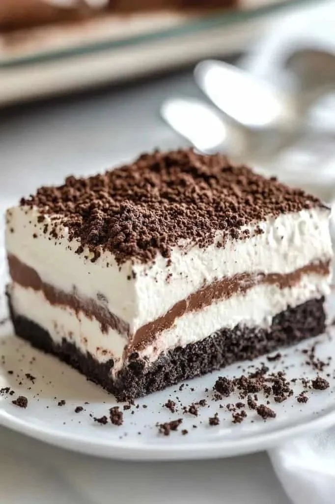 No Bake Oreo Lasagna Dessert showcasing layers of creamy goodness and crushed Oreos.