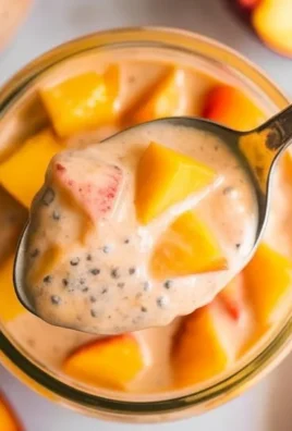 A bowl of Peach Chia Pudding topped with fresh peach slices and chia seeds.