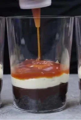 Delicious Snickers Trifle with layers of chocolate, caramel, and peanuts