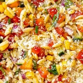 Delicious summer orzo pasta salad with fresh vegetables and dressing