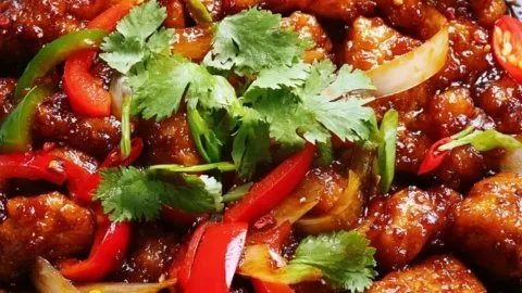 Delicious Sweet Chili Chicken served on a plate with fresh vegetables