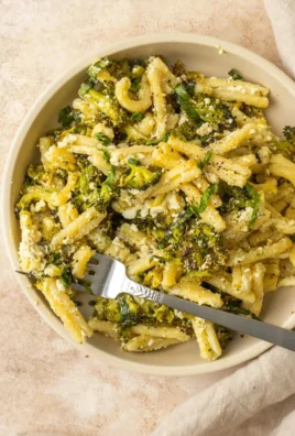 Baked Feta and Broccoli Pasta served in a bowl, garnished with herbs.
