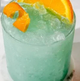 Refreshing Blue Hawaiian Mocktail garnished with pineapple and cherry