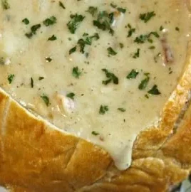 Bowl of Chunky New England Clam Chowder with fresh clams and herbs