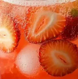 Delightful non-alcoholic strawberry limeade mocktail garnished with fresh strawberries and lime.