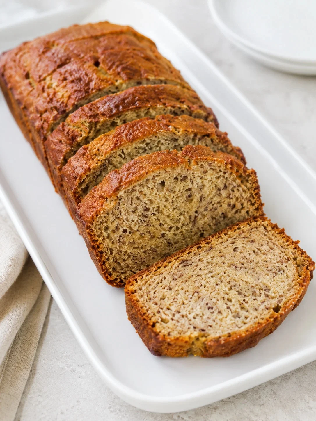 Slices of Greek Yogurt Banana Bread on a wooden board