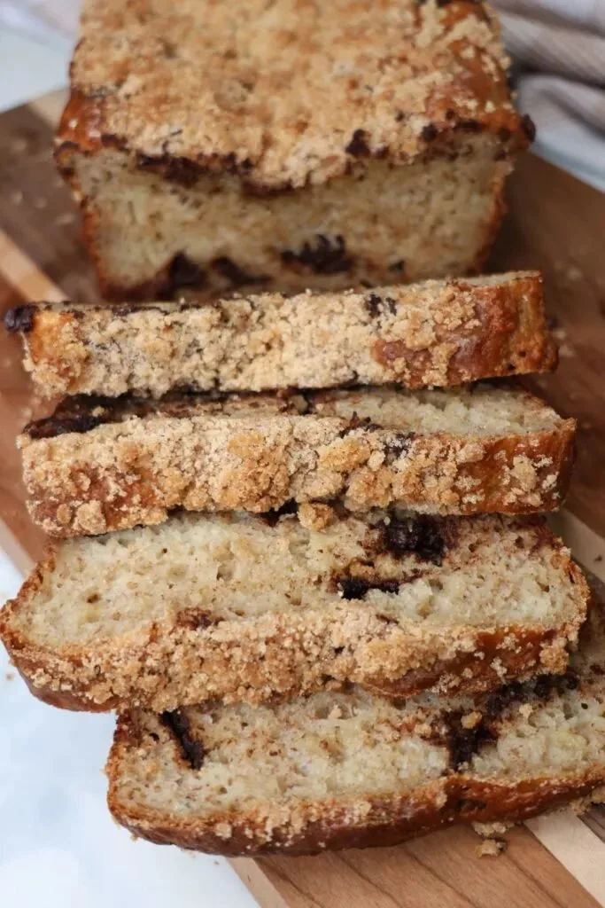Delicious Greek Yogurt Banana Bread freshly baked and sliced on a wooden cutting board.