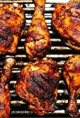 Grilled BBQ chicken with a smoky glaze on a barbecue grill