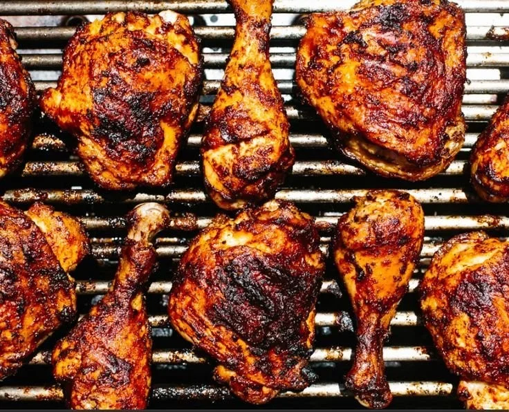 Grilled BBQ chicken with a smoky glaze on a barbecue grill